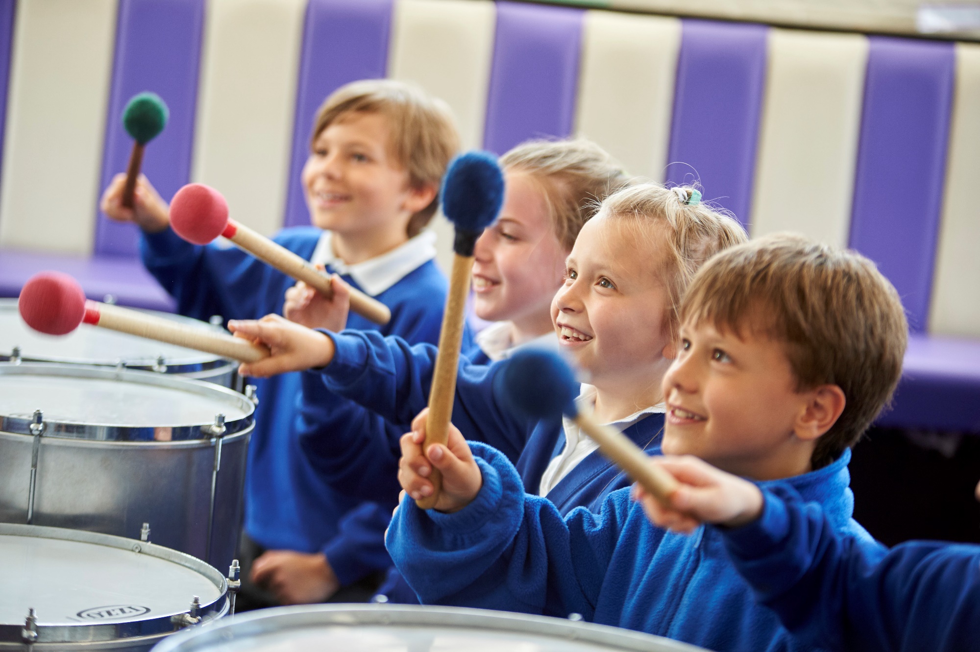 Children playing the samba drums during a music lesson